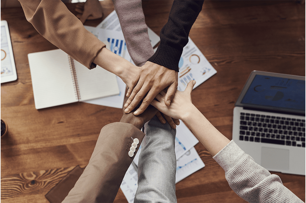 ABTyes-Services-Block-Business-Solutions-team-around-desk-chant